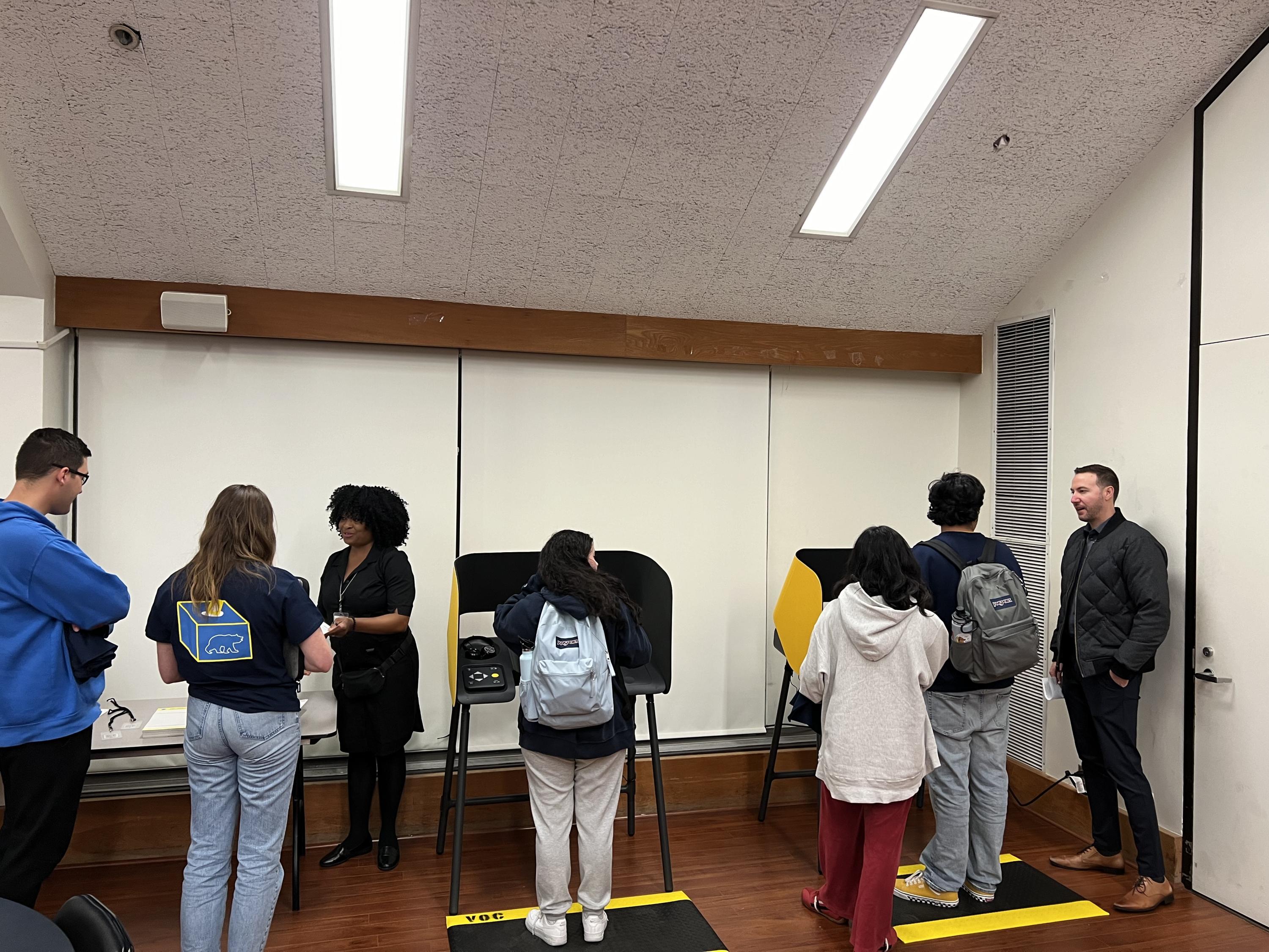 Picture of students using the LA County's Ballot Marking Devices (BMDs).